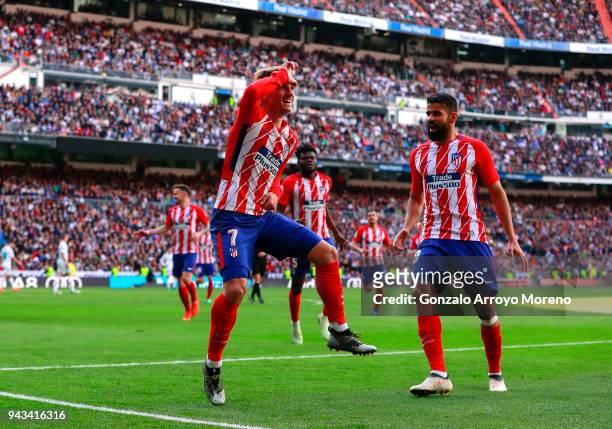 Antoine Griezmann of Atletico de Madrid celebrates scoring their opening goal with teammate Diego Costa during the La Liga match between Real Madrid...