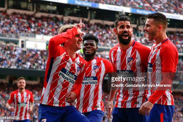 Antoine Griezmann of Atletico de Madrid celebrates scoring their opening goal with teammates Thomas Teye Partey , Diego Costa and Lucas Hernandez...