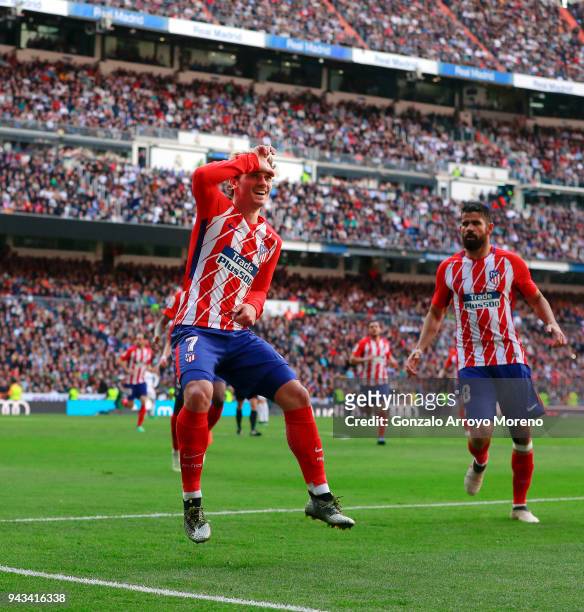 Antoine Griezmann of Atletico de Madrid celebrates scoring their opening goal with teammate Diego Costa during the La Liga match between Real Madrid...