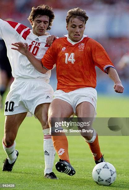 Rob Witschge of Holland is challenged by Igor Dobrovoski of the CIS during the European Championship Group 2 match at the Ullevi Stadium in...