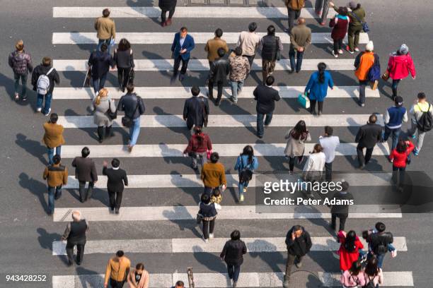 aerial view of people on busy pedestrian crossing, shanghai, china - crowd of people walking stock pictures, royalty-free photos & images