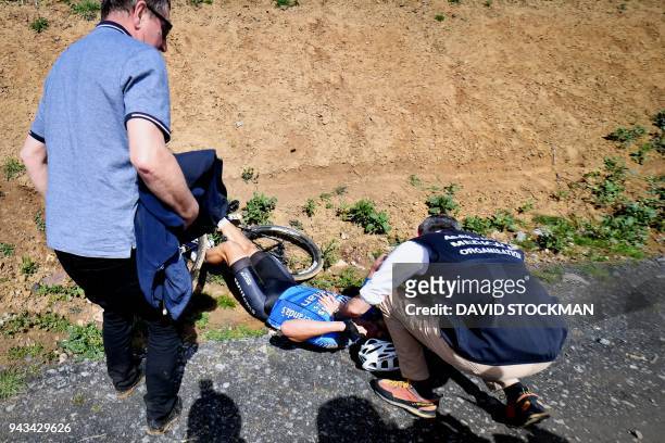 Belgium's Michael Goolaerts of Veranda's Willems-Crelan cycling team receives first aid after a crash during the 116th edition of the Paris-Roubaix...
