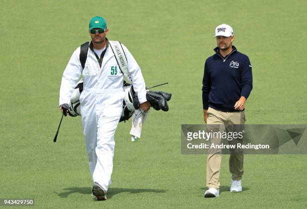 Ryan Moore of the United States and caddie J.J. Jakovac walk together on the second holeduring the final round of the 2018 Masters Tournament at...