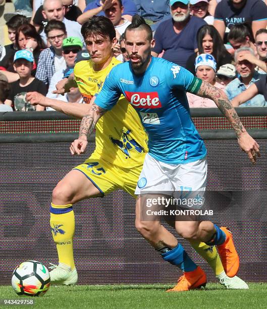 Napoli's Slovakian midfielder Marek Hamsik fights for the ball with Chievo's Italian striker Roberto Inglese during the Italian Serie A football...