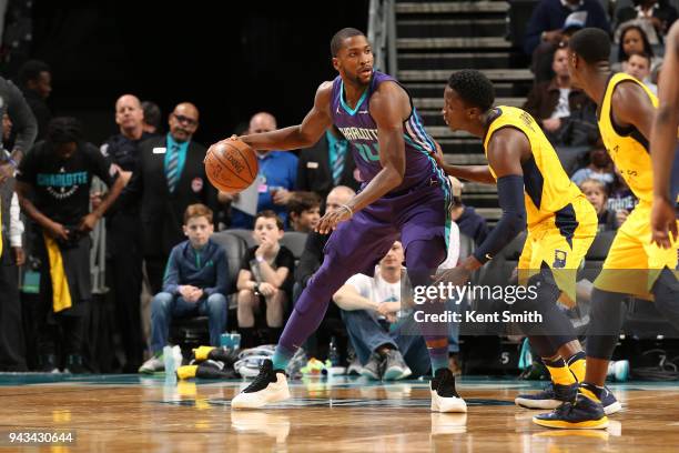 Michael Kidd-Gilchrist of the Charlotte Hornets handles the ball against Victor Oladipo of the Indiana Pacers on April 8, 2018 at Spectrum Center in...