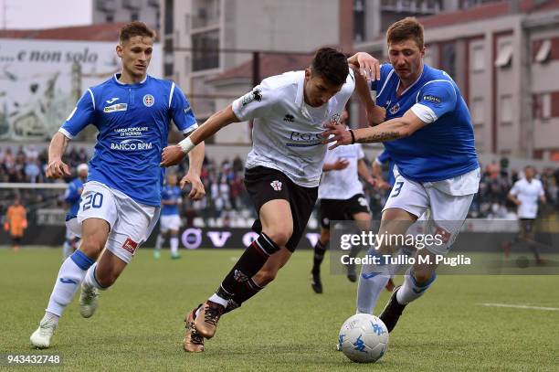 Claudio Morra of Pro Vercelli is challenged by Ronaldo Pompeu da Silva and Dario Del Fabro of Novara during the serie A match between Pro Vercelli FC...