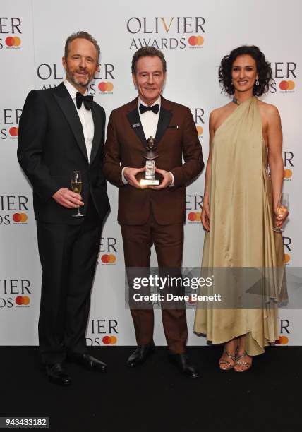 John Benjamin Hickey, Bryan Cranston, winner of the Best Actor award for "Network", and Indira Varma pose in the press room during The Olivier Awards...