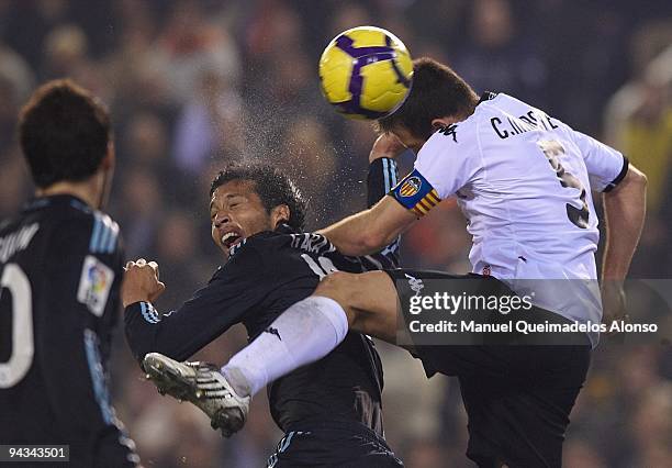 Ezequiel Garay of Real Madrid heads the ball of the third goal with Carlos Marchena of Valencia during the La Liga Match between Valencia and Real...