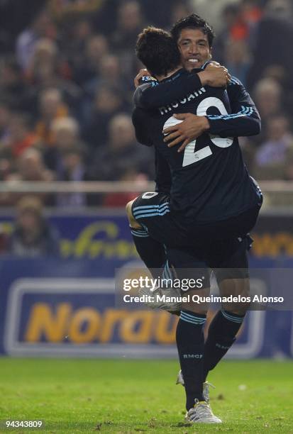 Ezequiel Garay of Real Madrid celebrates with his teammate Gonzalo Higuain during the La Liga Match between Valencia and Real Madrid at Estadio...