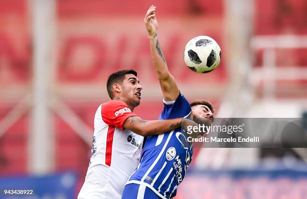 Angel Gonzalez of Godoy Cruz fights for the ball with Victor Salazar of San Lorenzo during a match between San Lorenzo and Godoy Cruz as part of...