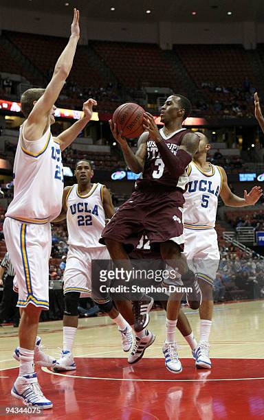 Dee Borst ofthe Mississippi State Bulldogs goes up with the ball against Brendan Lane of the UCLA Bruins in the John Wooden Classic on December 12,...