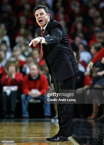 Rick Pitino the Head Coach of the Louisville Cardinals gives instructions to his team during the game against the Western Carolina Catamounts on...