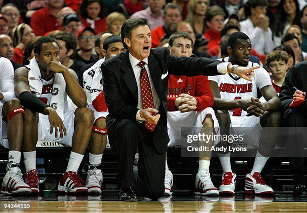 Rick Pitino the Head Coach of the Louisville Cardinals gives instructions to his team during the game against the Western Carolina Catamounts on...