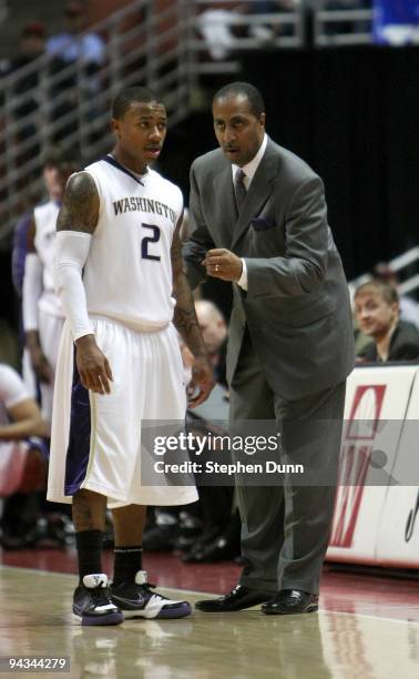 Head coach Lorenzo Romar of the Washington Huskies gives instructions to Isaiah Thomas during the game with the Georgetown Hoyas in the John Wooden...