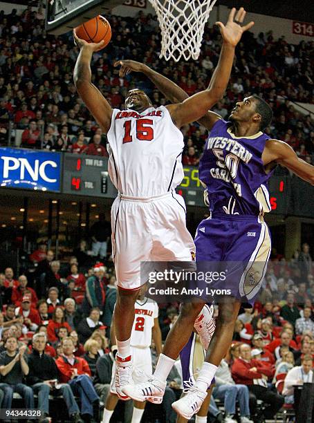 Samardo Samuels of the Louisville Cardinals shoots the ball while defended by Richie Gordon of the Western Carolina Catamounts during the game on...