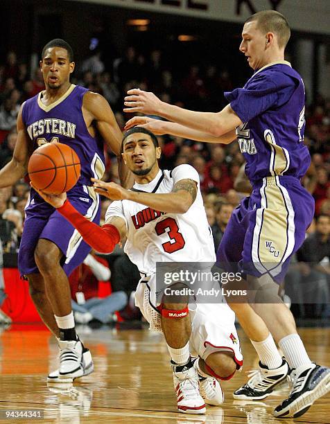 Peyton Siva of the Louisville Cardinals Jake Robinson of the Western Carolina Catamounts reach for a loose ball during the game on December 12, 2009...