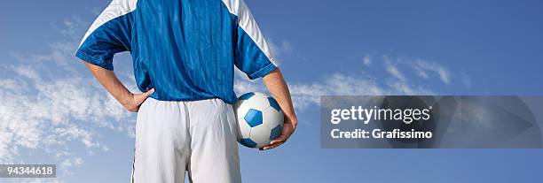 blue sky over soccer player about to play - jersey stockfoto's en -beelden