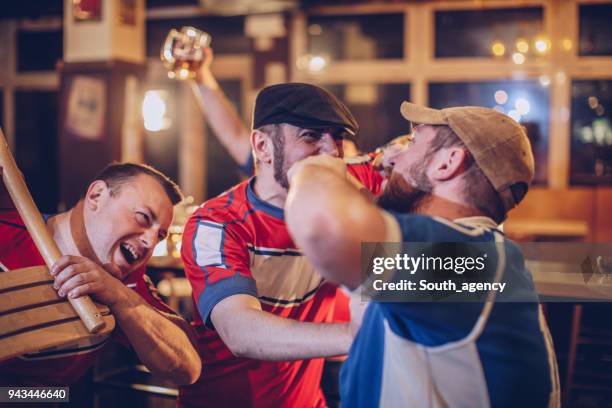 group of sport fans fighting in sports bar - shirt grab stock pictures, royalty-free photos & images