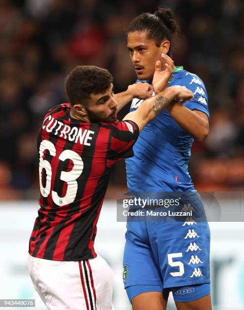 Patrick Cutrone of AC Milan competes with Mauricio Lemos of US Sassuolo during the serie A match between AC Milan and US Sassuolo at Stadio Giuseppe...