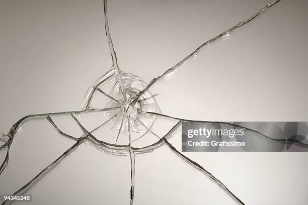 broken glass after bullet shot - windscreen stock pictures, royalty-free photos & images