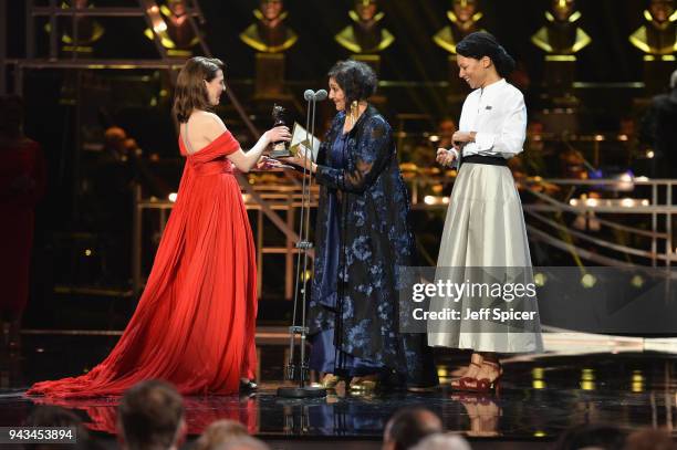 Meera Syal and Nina Sosanya present Ophelia Lovibond with the award for Best Actress In A Supporting Role on stage during The Olivier Awards with...