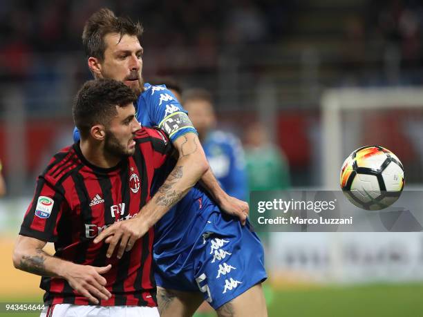 Patrick Cutrone of AC Milan competes for the ball with Francesco Acerbi of US Sassuolo during the serie A match between AC Milan and US Sassuolo at...