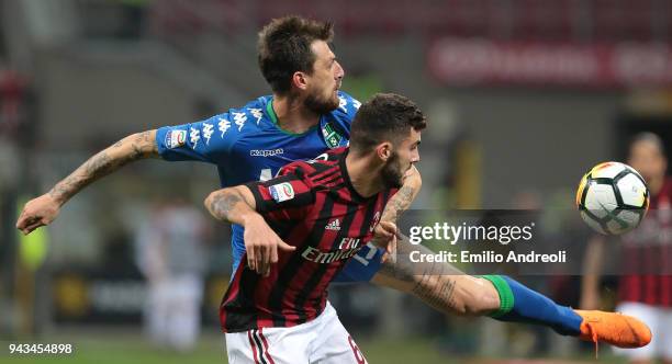 Patrick Cutrone of AC Milan competes for the ball with Francesco Acerbi of US Sassuolo Calcio during the serie A match between AC Milan and US...