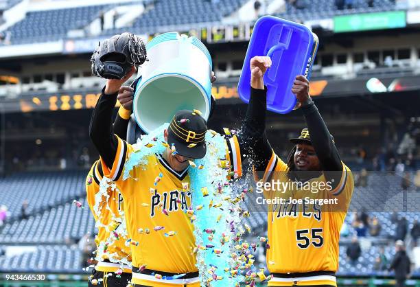 Jameson Taillon is doused with Powerade and bubble gum by Starling Marte and Josh Bell of the Pittsburgh Pirates after throwing a complete game...