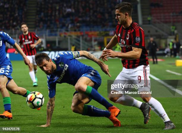 Andre Silva of AC Milan competes for the ball with Francesco Acerbi of US Sassuolo during the serie A match between AC Milan and US Sassuolo at...