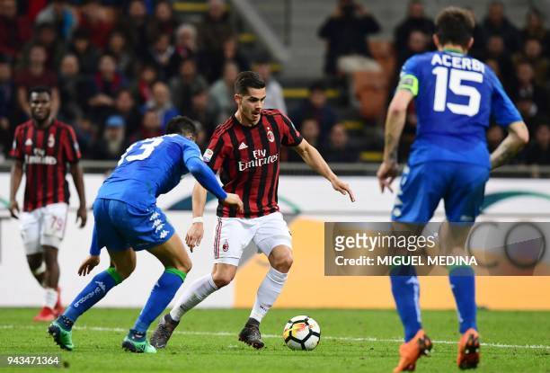 Milan's Portuguese forward Andre Silva vies with Sassuolo's Italian defender Federico Peluso during the Italian Serie A football match between AC...