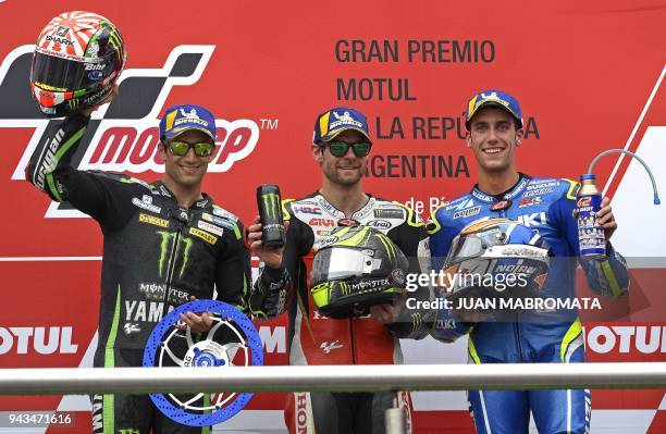 Honda biker Cal Crutchlow of Great Britain, Yamaha biker Johann Zarco of France and Suzuki biker Alex Rins of Spain celebrate their first, second and...