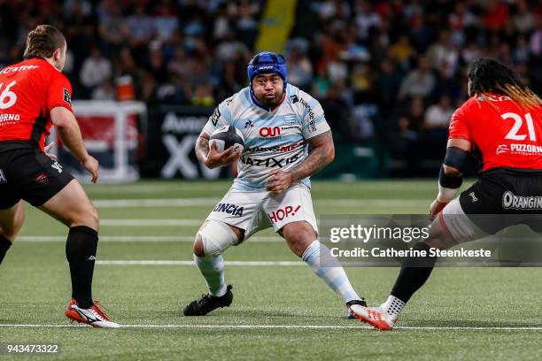 Ole Avei of Racing 92 runs with the ball against Anthony Etrillard and Ma'a Nonu of RC Toulon during the French Top 14 match between Racing 92 and RC...