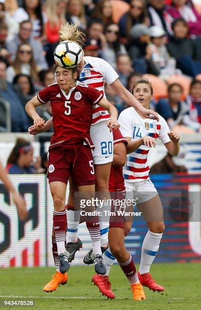 Monica Flores of Mexico heads the ball away from Allie Long of United States in the second half at BBVA Compass Stadium on April 8, 2018 in Houston,...