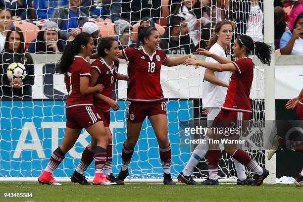 Kiana Palacios of Mexico is congratulated by Kenti Robles and Ariana Calderon after a goal in the first half against the United States at BBVA...