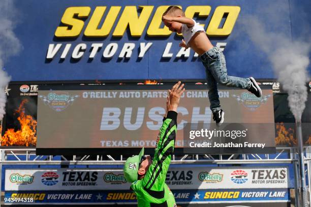 Kyle Busch, driver of the Interstate Batteries Toyota, celebrates in Victory Lane with his son Brexton after winning the Monster Energy NASCAR Cup...