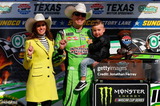 Kyle Busch, driver of the Interstate Batteries Toyota, poses in Victory Lane with his son Brexton and wife Samantha after winning the Monster Energy...