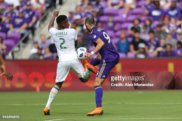 Alvas Powell of Portland Timbers plays the ball in front of Justin Meram of Orlando City SC during an MLS soccer match at Orlando City Stadium on...