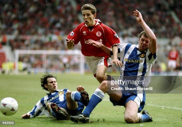 Juninho of Middlesbrough goes between Ryan Giggs and Gary Pallister of Manchester United during the FA Carling Premiership match at the Riverside...