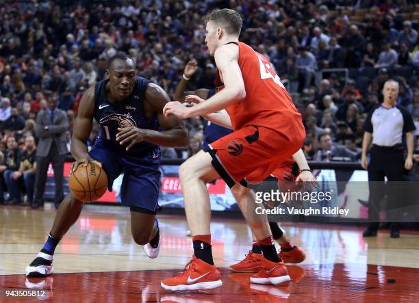 Bismack Biyombo of the Orlando Magic dribbles the ball as Jakob Poeltl of the Toronto Raptors defends during the first half of an NBA game at Air...