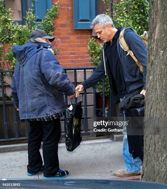 George Clooney talks to Radioman as he leaves his townhouse on April 8, 2018 in New York City.