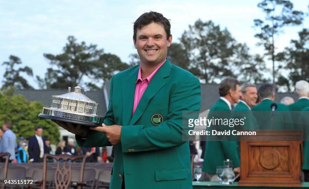 Patrick Reed of the United States celebrates with the trophy during the green jacket ceremony after winning the 2018 Masters Tournament at Augusta...