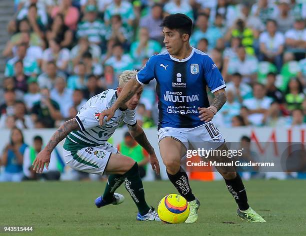 Edson Puch of Queretaro fights for the ball with Bryan Lozano of Santos during the 14th round match between Santos Laguna and Querataro as part of...