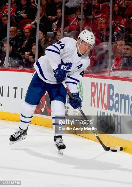 Morgan Rielly of the Toronto Maple Leafs plays the puck during the game against the New Jersey Devils at Prudential Center on April 5, 2018 in...