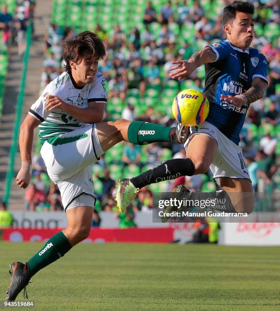 Javier Abella of Santos fights for the ball with Edson Puch of Queretaro during the 14th round match between Santos Laguna and Querataro as part of...