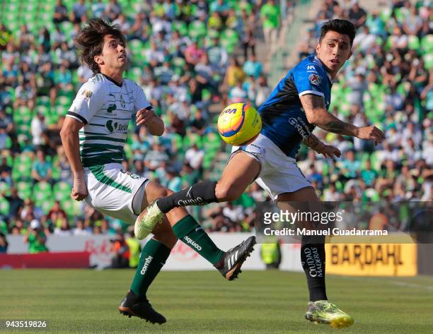Javier Abella of Santos fights for the ball with Edson Puch of Queretaro during the 14th round match between Santos Laguna and Querataro as part of...