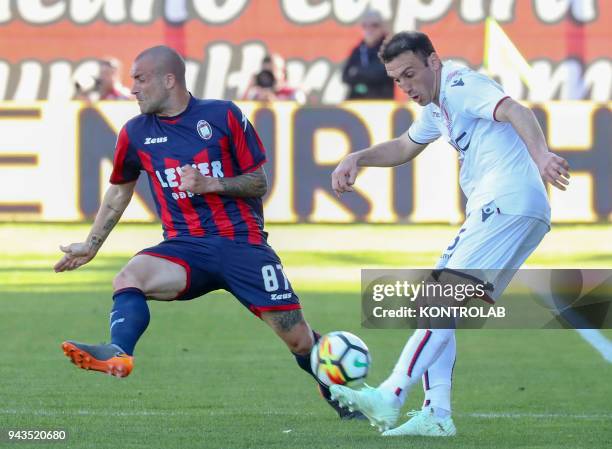 Bologna's Chilean midfielder Erick Pulgar fights for the ball with Crotone's Italian defender Bruno Martella during the Italian Serie A football...