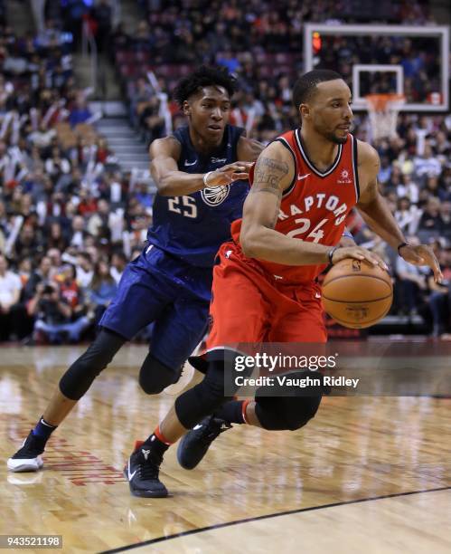 Norman Powell of the Toronto Raptors dribbles the ball as Wes Iwundu of the Orlando Magic defends during the second half of an NBA game at Air Canada...