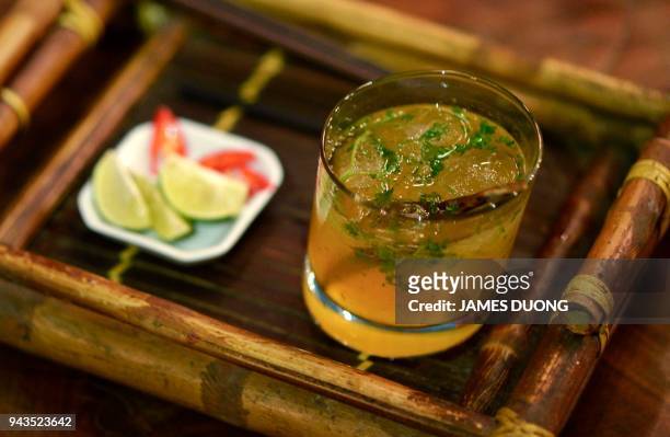 This picture taken on March 21, 2018 shows the Ne bar's signature "pho cocktail" in Hanoi. The Hanoi's hipster bar is making a splash with its...