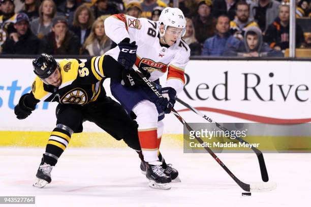 Maxim Mamin of the Florida Panthers and Adam McQuaid of the Boston Bruins battle for control of the puck during the second period at TD Garden on...