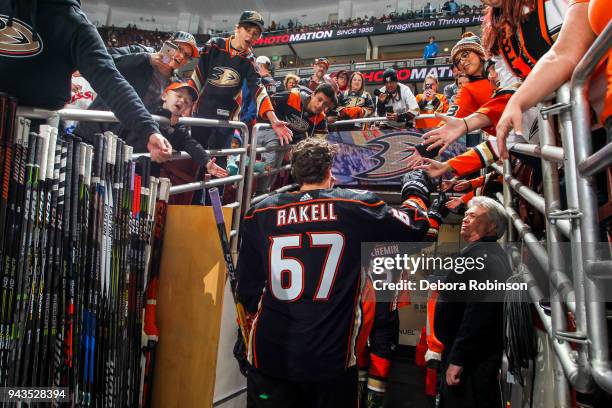 Rickard Rakell of the Anaheim Ducks and fans high five as he leaves the ice after warm-up before the game against the Dallas Stars at Honda Center on...